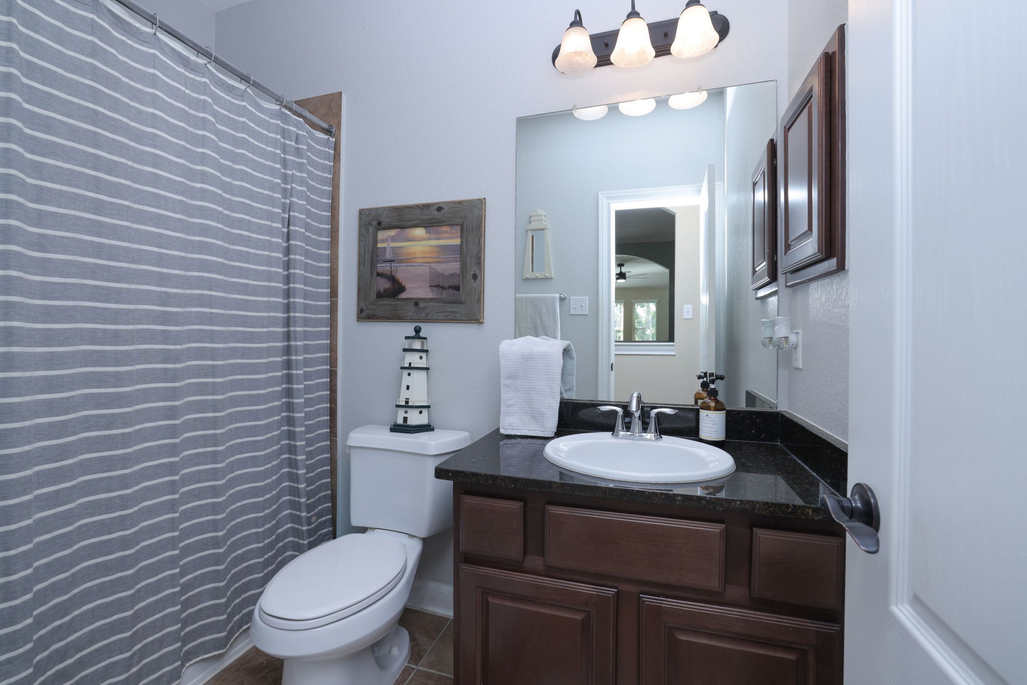 5922 Glen Lief Court Spring, TX 77379 - Photo 31 of 41 a bathroom with a toilet sink and mirror