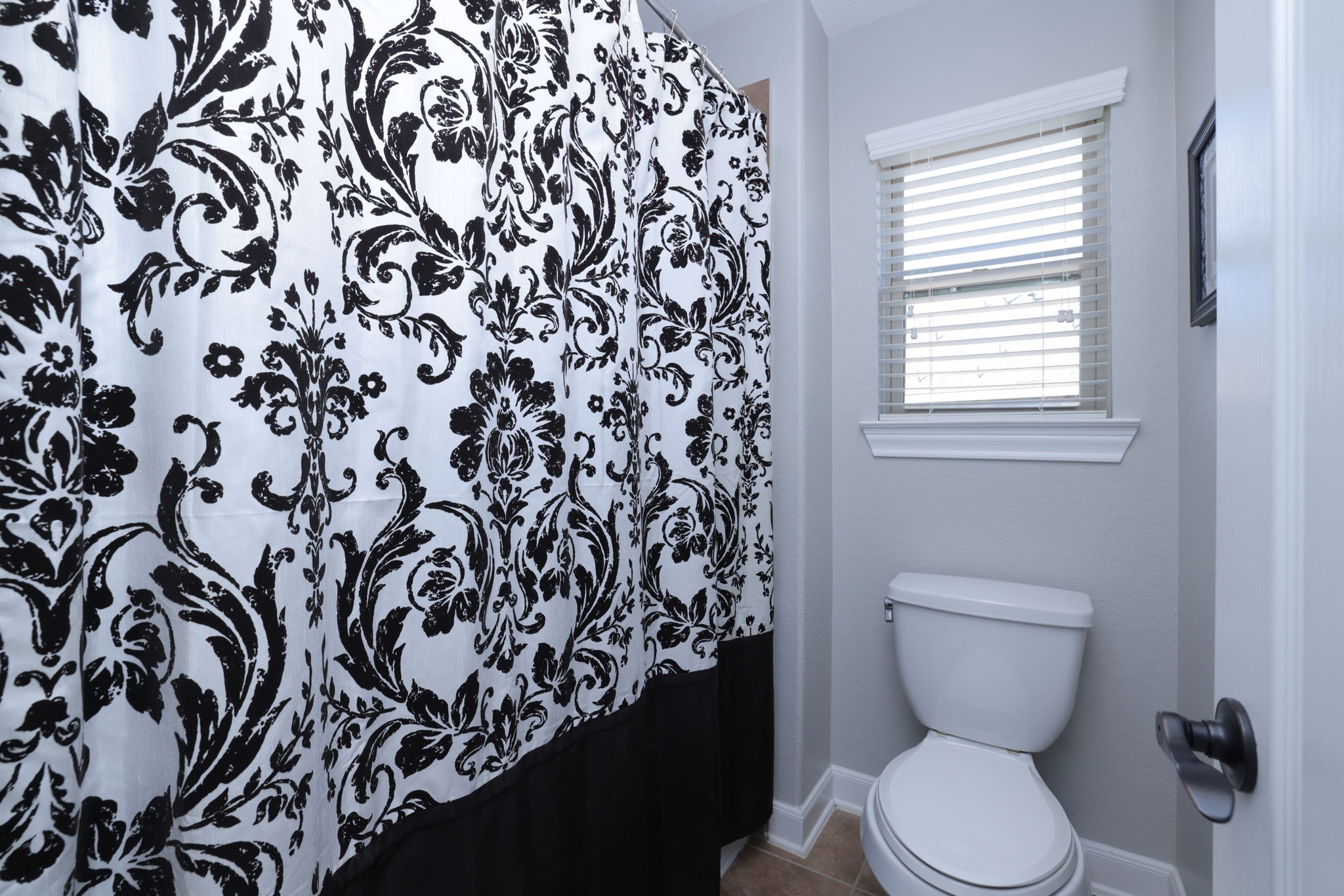 5922 Glen Lief Court Spring, TX 77379 - Photo 34 of 41 a bathroom with a toilet and a shower curtain