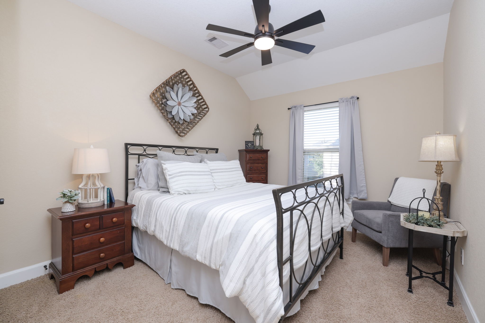 5922 Glen Lief Court Spring, TX 77379 - Photo 35 of 41 a bedroom with a bed and a chandelier
