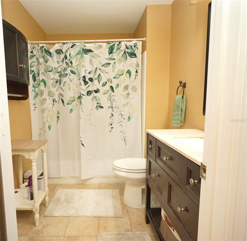 1014 Normandy Trace Road Tampa, FL 33602 - Photo 6 of 7 a bathroom with a granite countertop sink toilet and shower