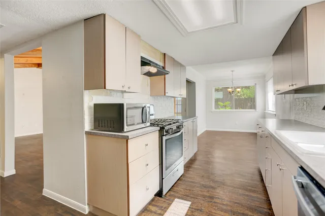 a kitchen with stainless steel appliances granite countertop a stove and a sink