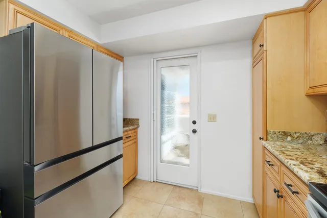 a kitchen with stainless steel appliances granite countertop a sink and a stove