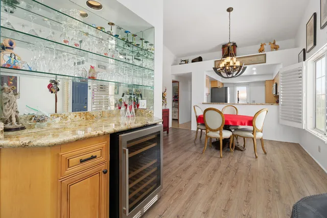 a living room with furniture kitchen view and a window