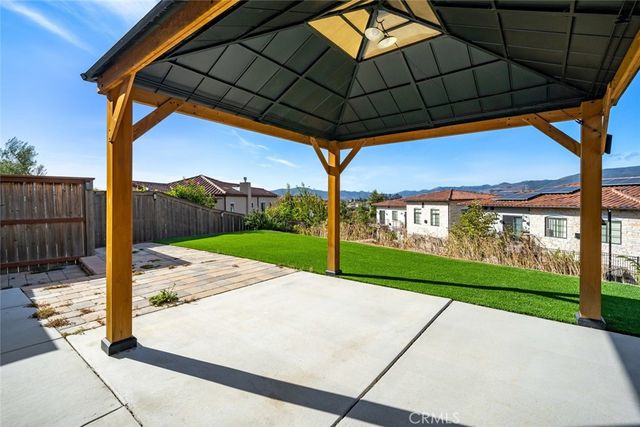 a view of a house with a yard and a fountain