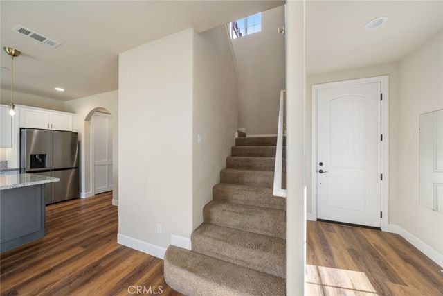 a view of an entryway with wooden floor and a livingroom view