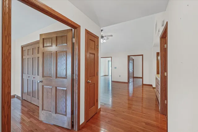 a view of a hallway with wooden floor