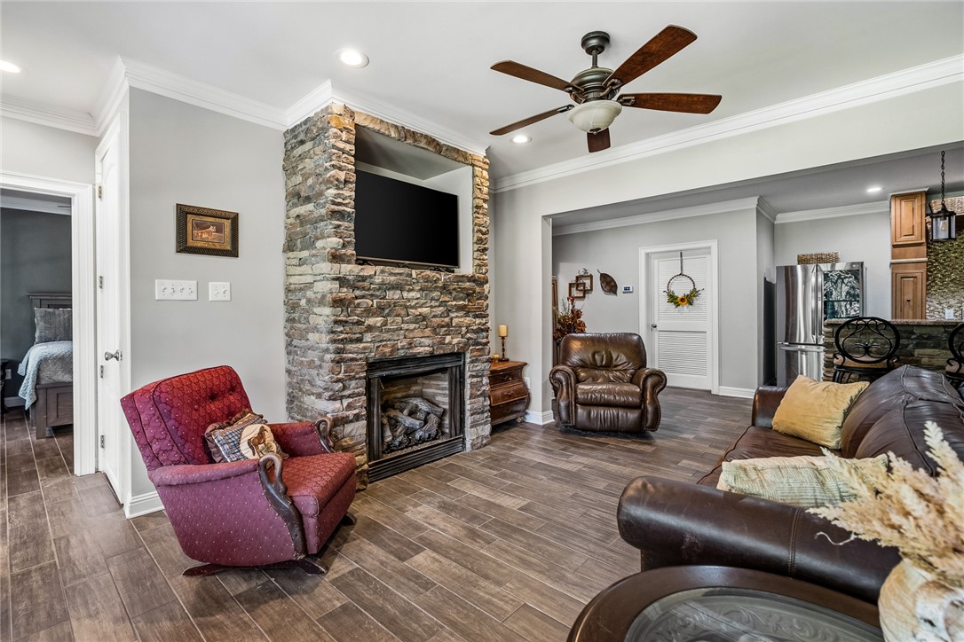 206 James Hare Road Anderson, SC 29626 - Photo 26 of 50 A striking stone-clad fireplace commands attention in this inviting, wood-floored living area.