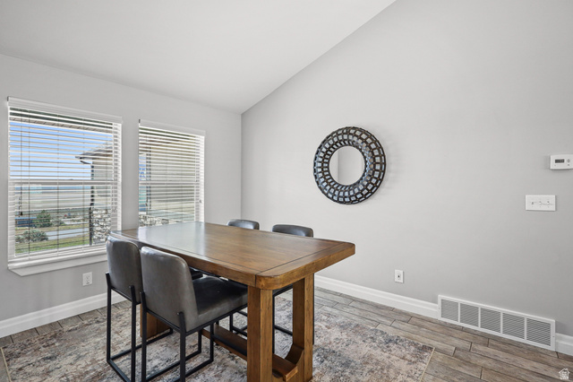 1588 West Rim Rock Drive Stockton, UT 84071 - Photo 6 of 61 Vaulted ceiling with light gray walls and wood-finish flooring