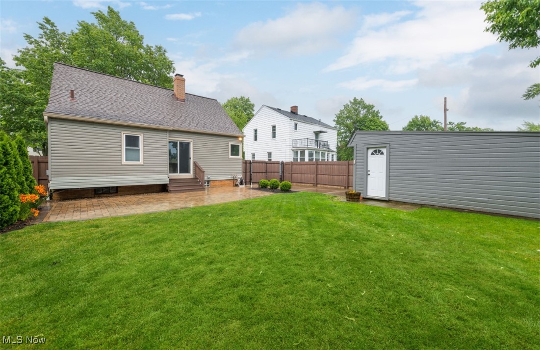 16501 Munn Road Cleveland, OH 44111 - Photo 42 of 42 Back of property featuring entry steps, a patio, a chimney, and a fenced backyard