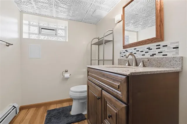 a bathroom with a sink toilet and mirror