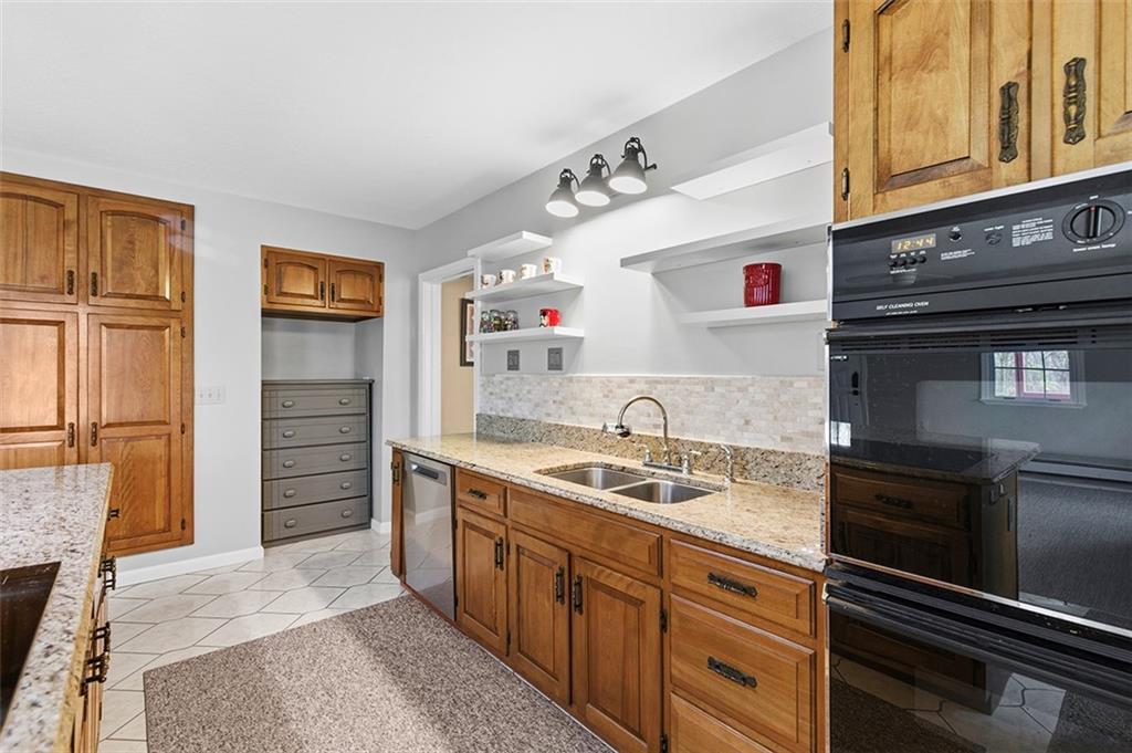 2034 Ewings Mill Road Coraopolis, PA 15108 - Photo 7 of 48 a kitchen with a sink stove and refrigerator