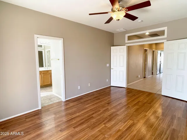 a view of an empty room with wooden floor