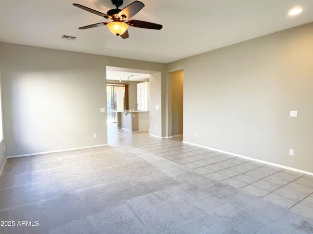a view of a livingroom with a ceiling fan and window
