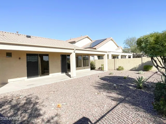 a front view of a house with a garden and patio