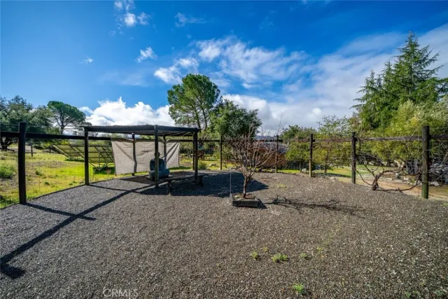 an aerial view of a house with a yard and mountain view in back