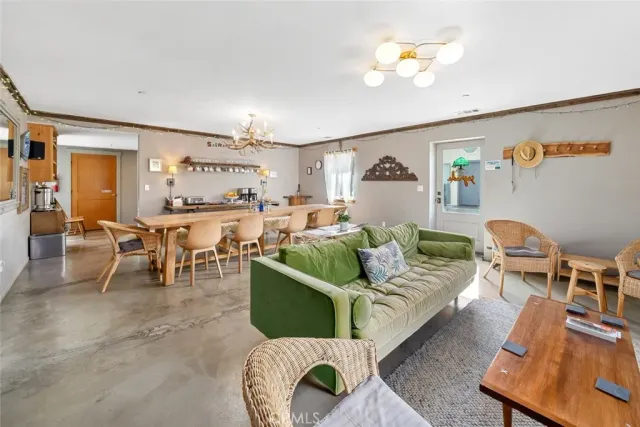 a kitchen with a refrigerator a stove a sink dishwasher and a dining table with the view of kitchen