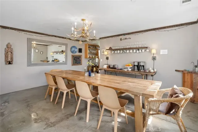 a kitchen with granite countertop a stove and a dining table with wooden floor