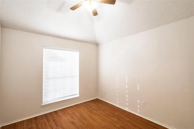 a bathroom with a bathtub shower sink mirror vanity and toilet