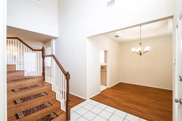 a view of a hallway view with wooden floor and staircase