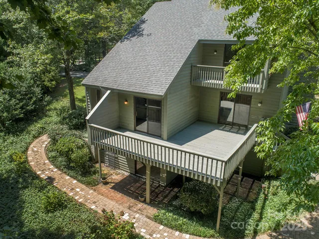 a terrace view with table and chairs potted plants and floor to ceiling window