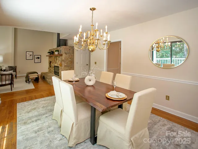 a view of a dining room with furniture and chandelier