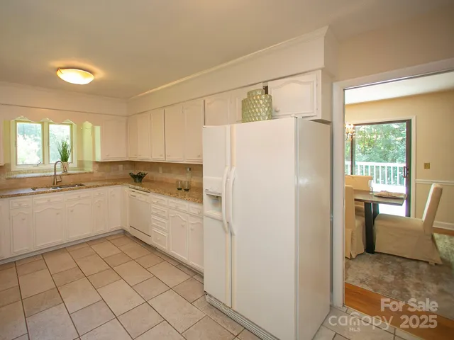 a white refrigerator freezer sitting inside of a kitchen