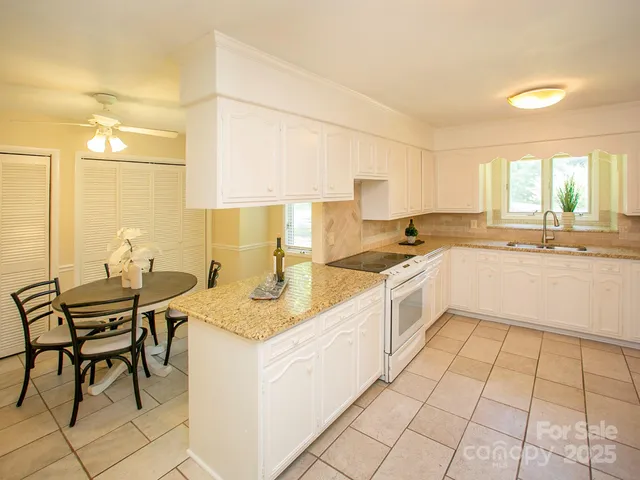 a kitchen with a sink cabinets and window