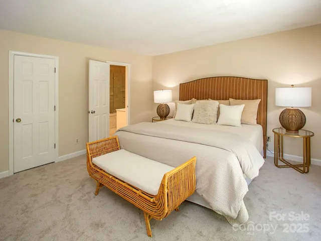 a bedroom with a bed and lamp