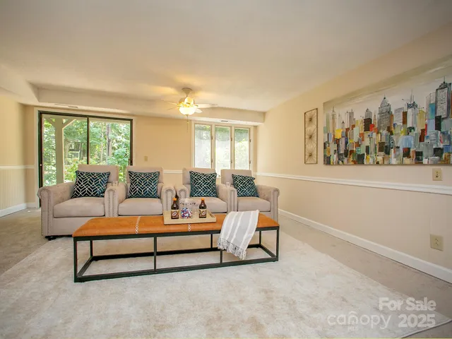 a living room with furniture and a large window