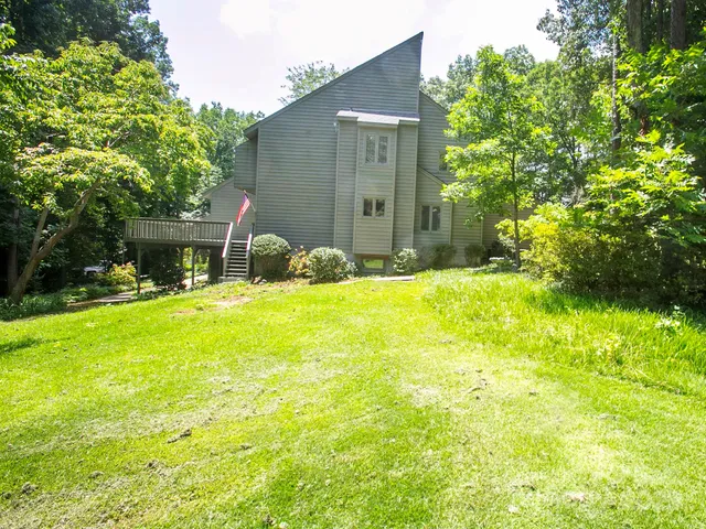 a house view with swimming pool in front of it