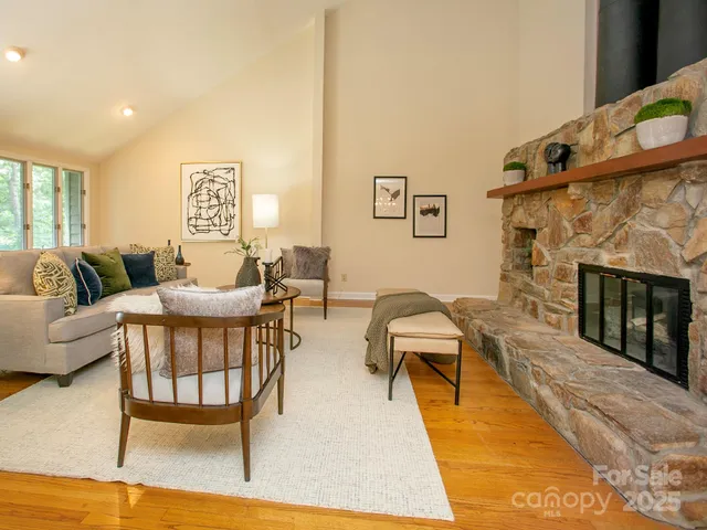 a living room with furniture a fireplace and a table