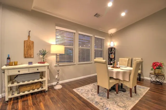 a bedroom with a bed and a dresser next to a window