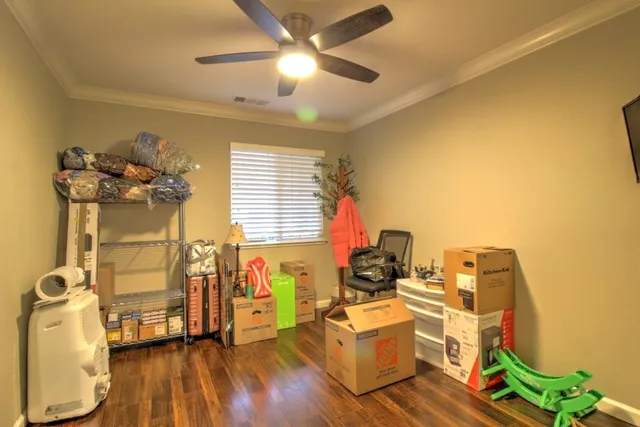 a spacious bedroom with a bed and a flat screen tv