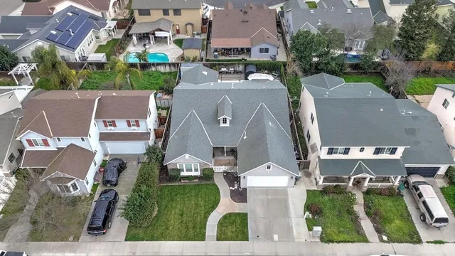 an aerial view of residential houses with outdoor space and street view