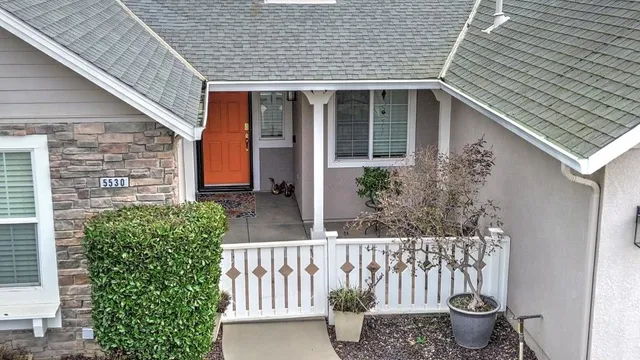 a kitchen with stainless steel appliances granite countertop sink stove refrigerator and cabinets
