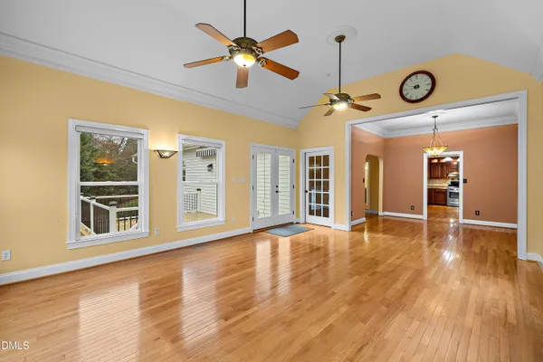 a view of an room with wooden floor and a large window
