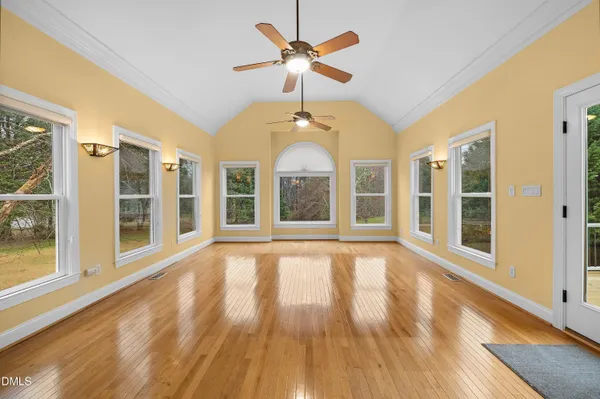 a view of an room with wooden floor and chandelier