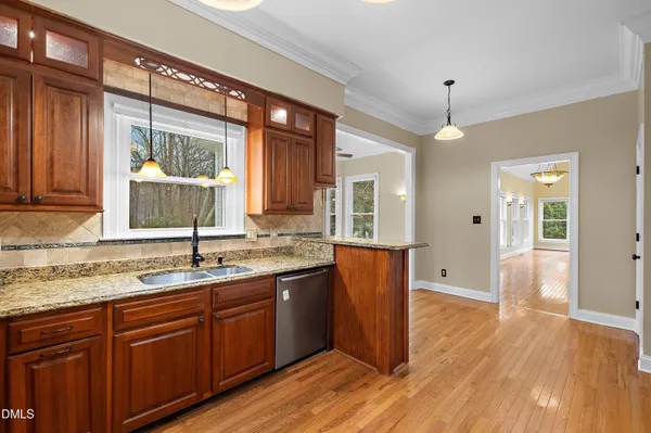 a kitchen with granite countertop a sink and a window