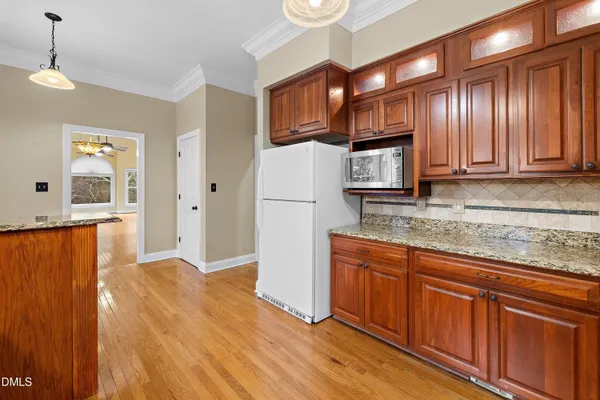 a kitchen with granite countertop cabinets washer and dryer
