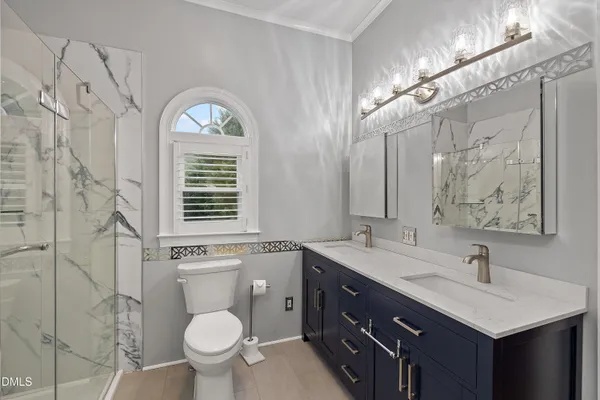 an empty room with wooden floor and ceiling fan