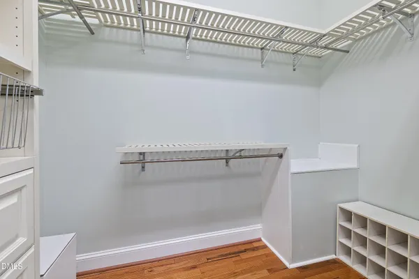 a view of empty room with wooden floor