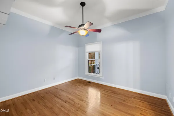 a view of a white house with a yard covered in snow