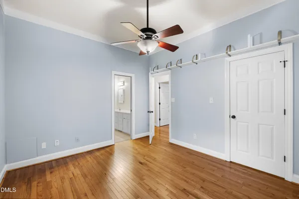 a view of a white house with a yard and large tree