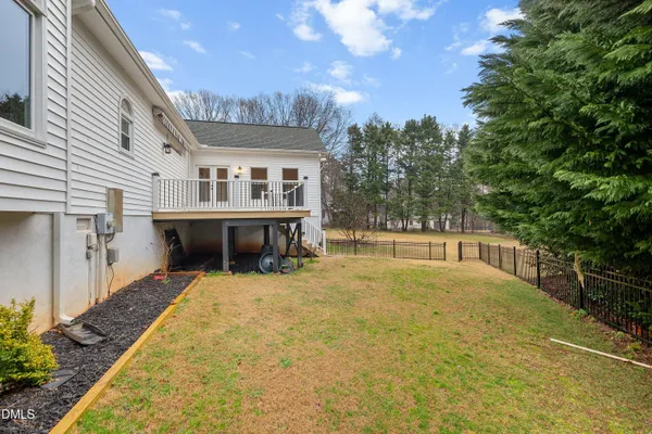 a view of a house with a big yard and large trees