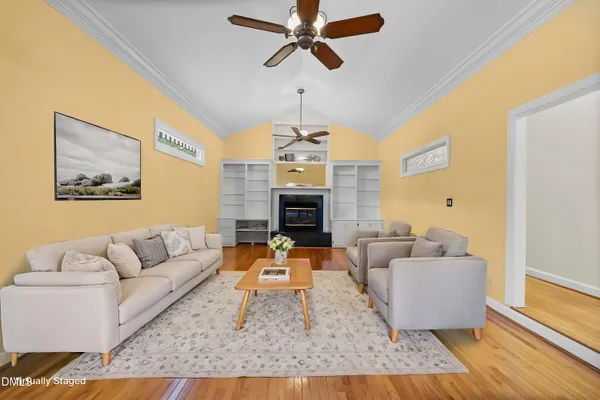 a view of empty room with a fireplace and wooden floor