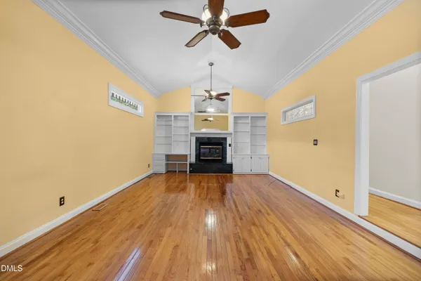 a view of an empty room with wooden floor