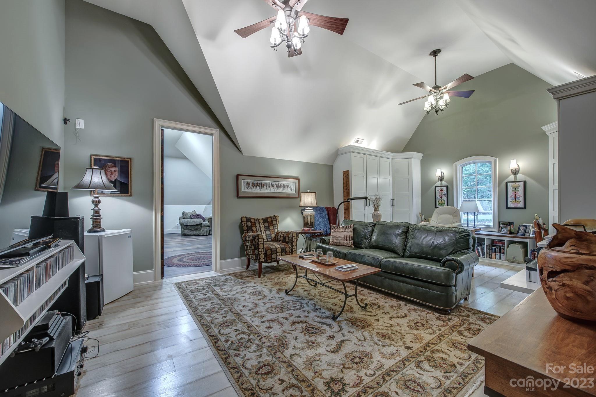 505 Stuart Ridge Cramerton, NC 28032 - Photo 19 of 33 a living room with furniture kitchen view and a wooden floor