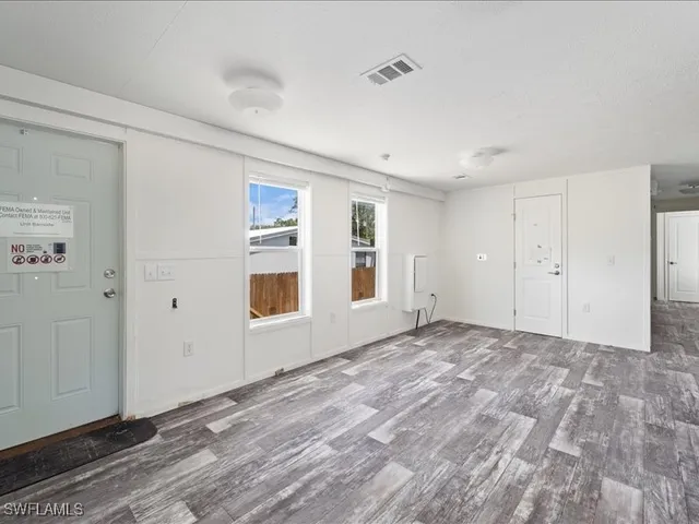 a large kitchen with a stove top oven a refrigerator and a sink