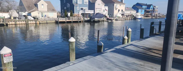 a view of residential houses with outdoor space and lake view