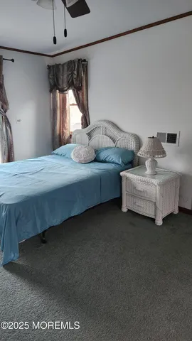 a bedroom with bed and window